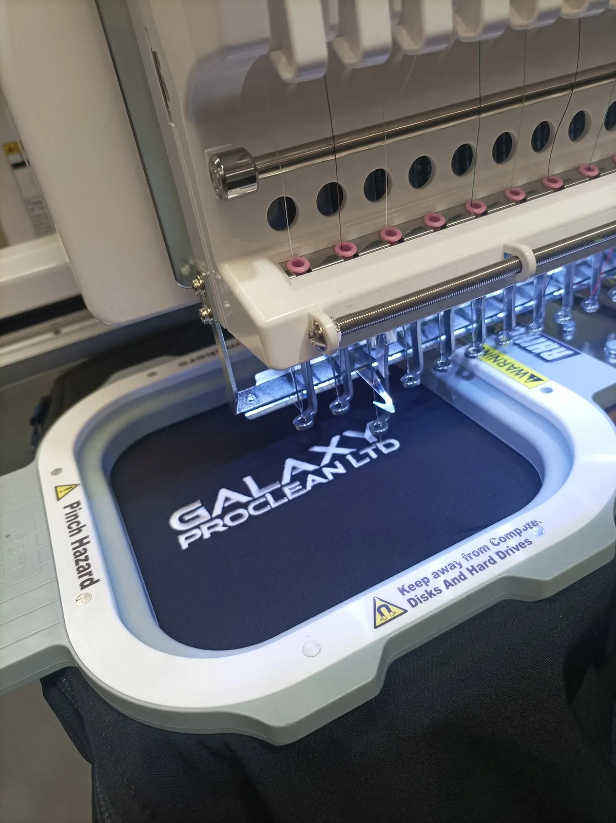 Southport Workwear embroidery machine stitching a customer company logo onto workwear