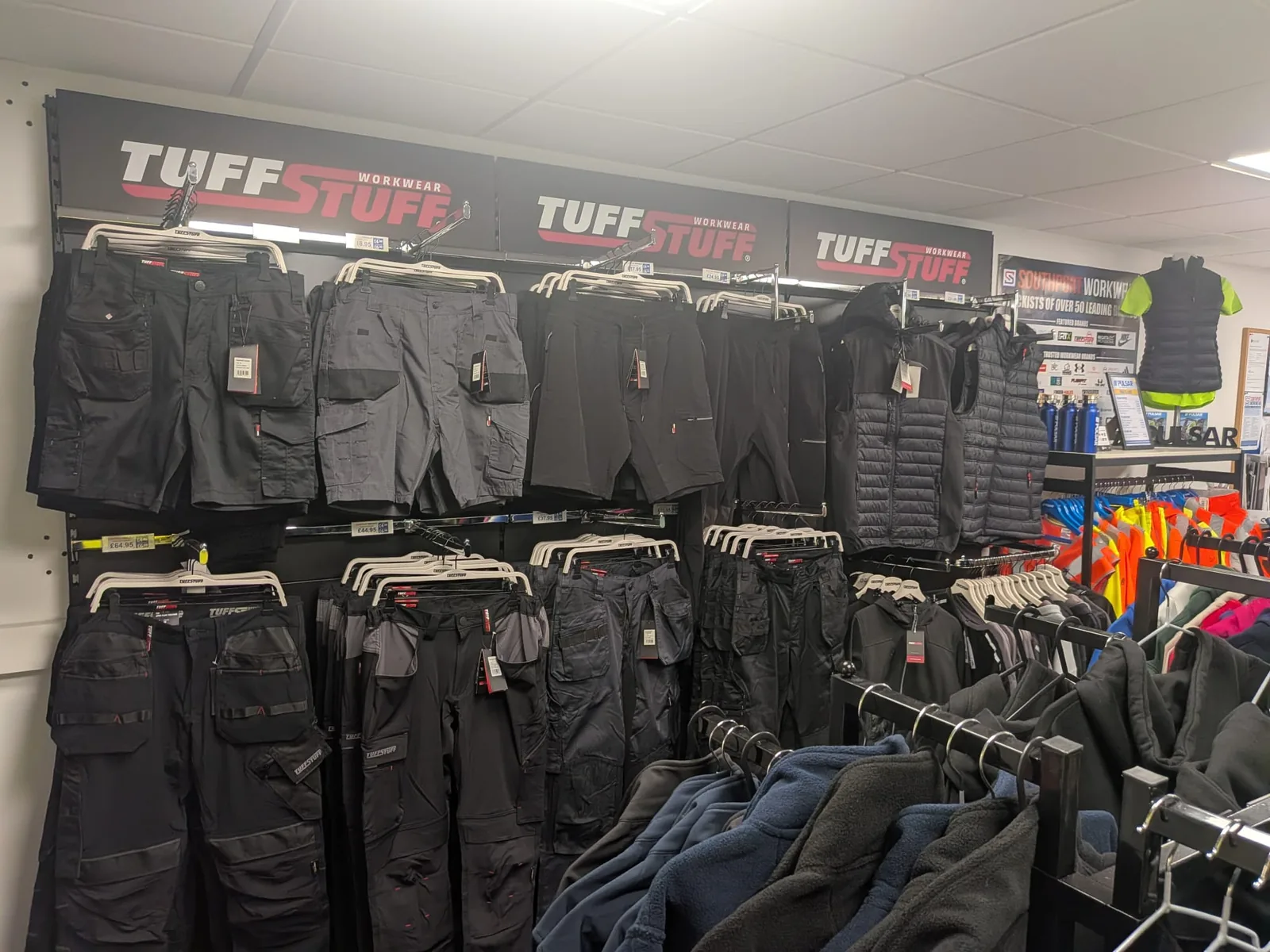 TuffStuff work trousers, shorts and bodywarmers displayed in the Southport Workwear showroom